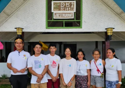 The DK2 Resort family and team smiling at the restaurant entrance. Friendly local hospitality in El Nido, Palawan.