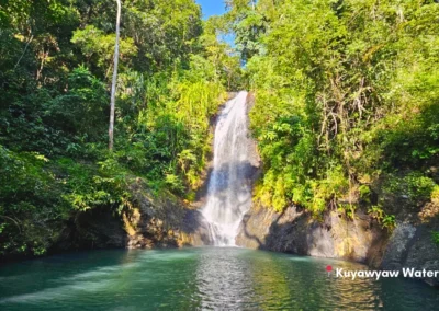 Main waterfall at Kuyawyaw Nature Park in Taytay, Palawan, cascading into a freshwater pool surrounded by lush green jungle.