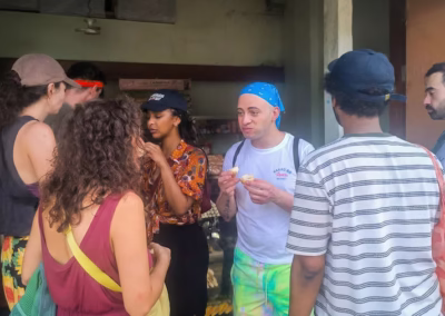 Group of travelers tasting freshly baked bread from a small village bakery.